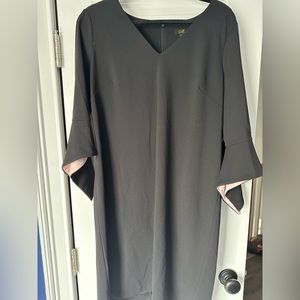 Stunning black dress with pink accent inside sleeve.